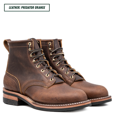 A pair of dark brown leather lace-up boots with distressed detailing, shown on a white background with a text label in the top left corner that reads 'LEATHER: PREDATOR ORANGE'.