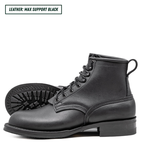 A black leather lace-up ankle boot shown in profile on a white background, with a second boot placed behind it to show the sole tread. A small text label in the top left reads 'LEATHER: MAX SUPPORT BLACK'.