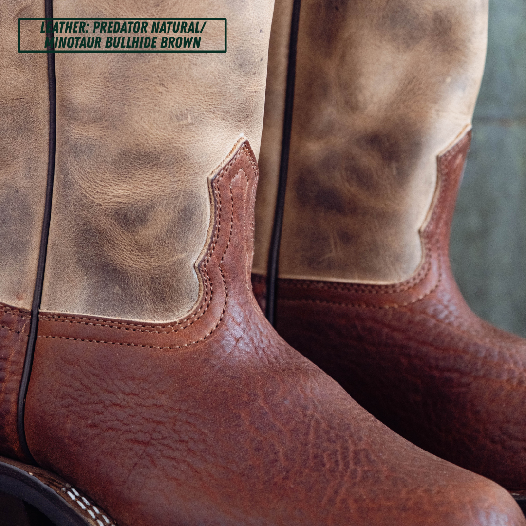 Close-up of a pair of cowboy boots showing the leather shaft and lower vamp in a natural tan/brown finish, with a text label in the top left reading 'LEATHER: PREDATOR NATURAL / MINOTAUR BULLHIDE BROWN'.