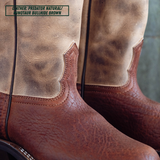 Close-up of a pair of cowboy boots showing the leather shaft and lower vamp in a natural tan/brown finish, with a text label in the top left reading 'LEATHER: PREDATOR NATURAL / MINOTAUR BULLHIDE BROWN'.
