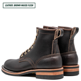 A pair of dark brown waxed leather lace-up ankle boots shown from a three-quarter angle on a white background, with a text label in the top-left corner reading 'LEATHER: BROWN WAXED FLESH'.