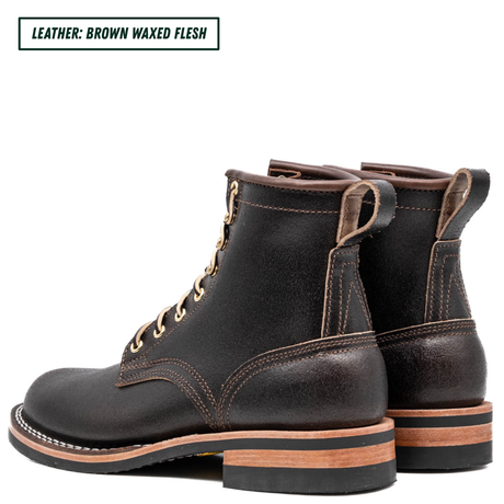 A pair of dark brown waxed leather lace-up ankle boots shown from a three-quarter angle on a white background, with a text label in the top-left corner reading 'LEATHER: BROWN WAXED FLESH'.