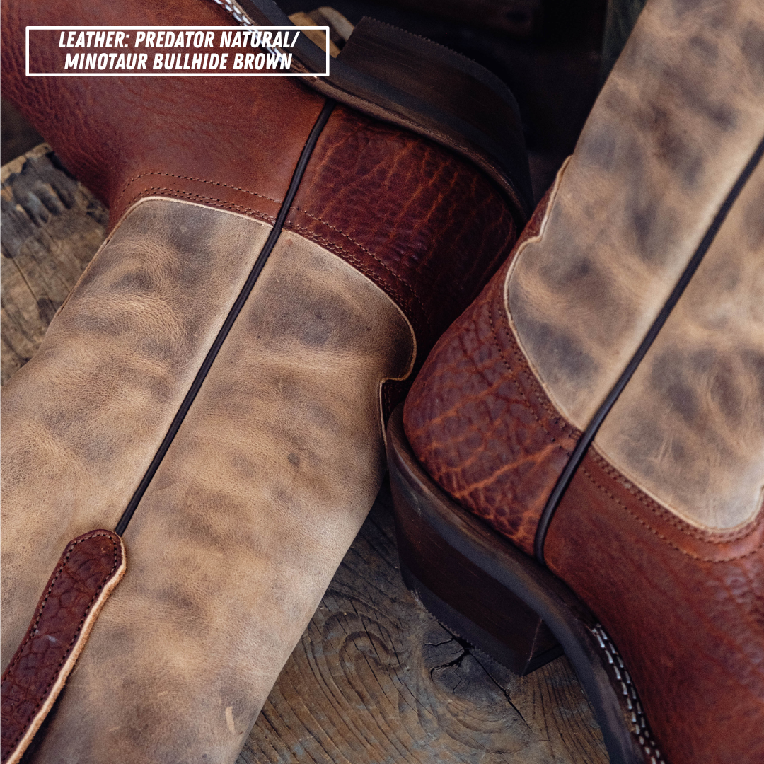 Close-up of a pair of western boots showing mixed leather panels in natural tan and reddish-brown, with a text label reading 'LEATHER: PREDATOR NATURAL / MINOTAUR BULLHIDE BROWN'.