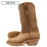 A tan suede western-style boot shown in side profile on a white background, with a second boot placed behind it to show the sole. A small label in the top left reads 'LEATHER: 1964 TAN'.