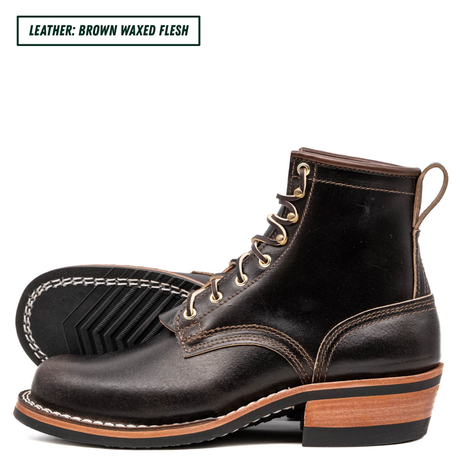 A pair of men's brown waxed leather lace-up boots shown on a white background, with one boot standing upright and the other lying on its side to display the sole. A text label in the top-left corner reads 'LEATHER: BROWN WAXED FLESH'.