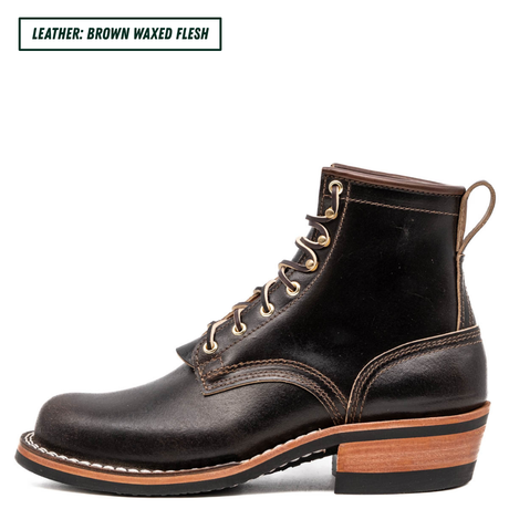 A single dark brown leather lace-up boot shown in side profile on a white background, with a small text label in the top-left corner reading 'LEATHER: BROWN WAXED FLESH'. The boot has tan contrast stitching, brass eyelets, a pull loop, and a stacked wood-look heel.