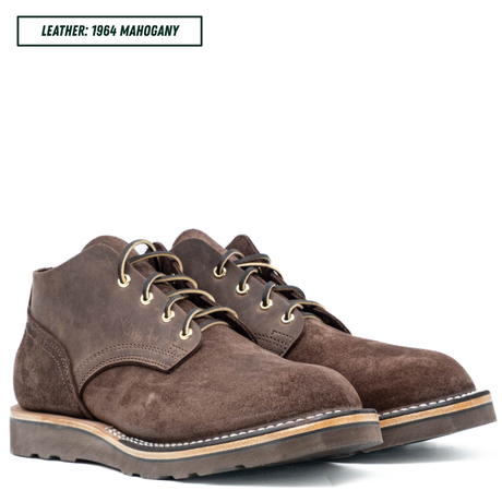 A pair of dark brown suede lace-up boots on a white background, with a text label in the top-left corner reading 'LEATHER: 1964 MAHOGANY'.