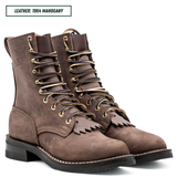 A pair of brown suede lace-up boots with gold-toned eyelets and fringe detail on the vamp, shown on a white background with a text label reading 'LEATHER: 1964 MAHOGANY'.