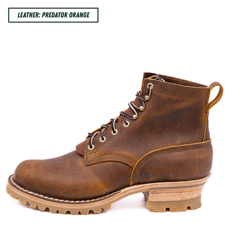 A single brown leather lace-up boot shown in side profile on a white background, with a text label in the top-left corner reading 'LEATHER: PREDATOR ORANGE'. The boot has a distressed finish, tan stitching, metal eyelets, and a rugged lug sole.