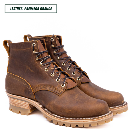 A pair of rugged lace-up ankle boots in distressed brown leather, shown on a white background with a text label at the top reading 'LEATHER: PREDATOR ORANGE'.