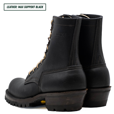 A pair of black leather lace-up ankle boots shown from the side and back on a white background, with a text label in the top-left corner reading 'LEATHER: MAX SUPPORT BLACK'.