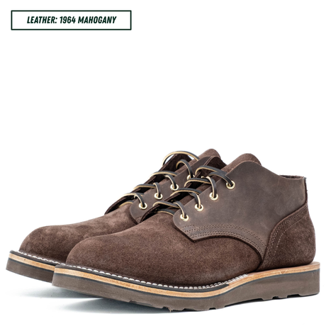 A pair of dark brown suede lace-up boots on a white background, with a text label in the top-left corner reading 'LEATHER: 1964 MAHOGANY'.