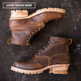 A pair of rugged lace-up ankle boots in distressed brown leather, arranged diagonally on a dark textured background. A text overlay in the top left reads 'LEATHER: PREDATOR ORANGE'.