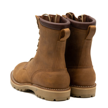 Pair of brown leather boots on a white background
