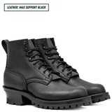 Black leather boots with thick soles on a white background