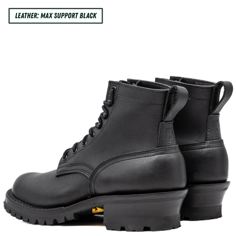 A pair of black leather lace-up ankle boots with rugged lug soles, shown from a side angle on a white background. A text label in the top-left corner reads 'LEATHER: MAX SUPPORT BLACK'.
