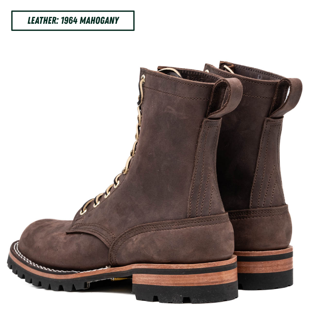 A pair of dark brown suede lace-up boots shown from the side and back on a white background, with a text label in the top-left corner reading 'LEATHER: 1964 MAHOGANY'.