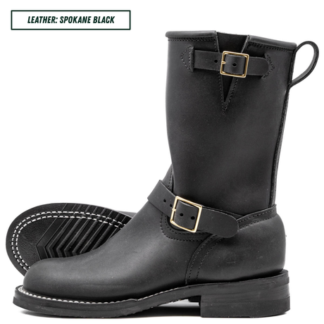 A pair of black leather mid-calf boots with gold-tone buckle straps, shown on a white background with one boot standing upright and the other lying flat to display the sole.