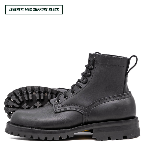 Black leather boots with thick soles on a white background