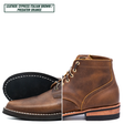 A single lace-up ankle boot shown on a white background with a split view: the left half shows the black outsole with white stitching, and the right half shows the brown leather upper. Text at the top reads 'LEATHER: CYPRESS ITALIAN BROWN / PREDATOR ORANGE'.