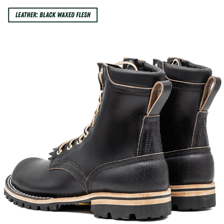 A pair of black waxed leather lace-up boots shown from the side and back on a white background, with a text label in the top-left corner reading 'LEATHER: BLACK WAXED FLESH'.