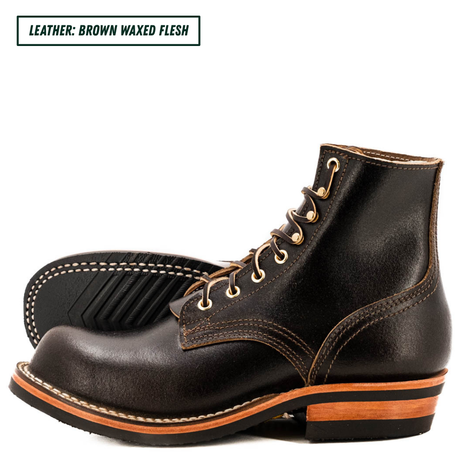A pair of dark brown waxed leather lace-up boots shown on a white background, with a text label in the top left reading 'LEATHER: BROWN WAXED FLESH'. The boots feature light tan stitching, gold eyelets, and a black sole with a tan midsole.