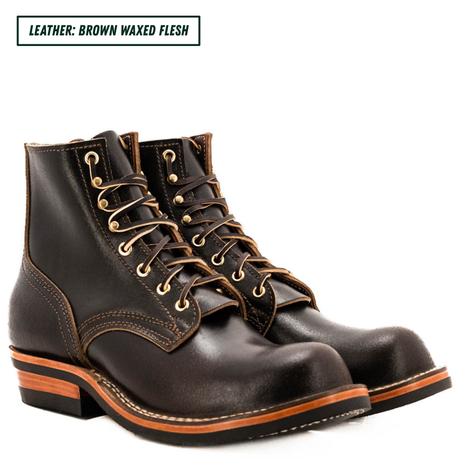 A pair of dark brown waxed leather lace-up boots with gold-toned metal eyelets and contrast stitching, shown on a white background with a text label in the top left corner.