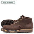 A pair of dark brown leather lace-up boots shown on a white background, with one boot standing upright and the other lying on its side to display the tread. A text label in the top left reads 'LEATHER: 1964 MAHOGANY'.