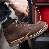 A person's hand tying the laces of a brown leather ankle boot, with the text 'LEATHER: 1964 MAHOGANY' in the top-left corner. The boot is shown in a close-up lifestyle setting against a red vehicle bumper.