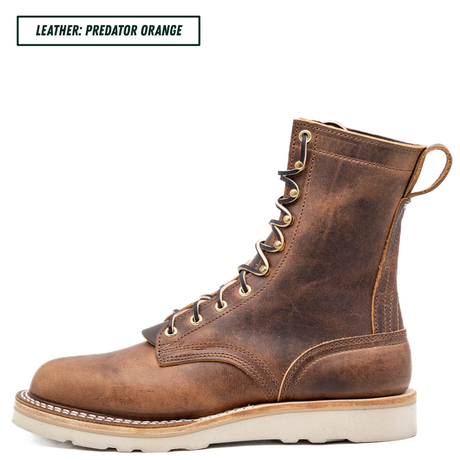 A single lace-up ankle boot in distressed brown leather, shown in profile against a plain white background. A small label in the top-left corner reads 'LEATHER: PREDATOR ORANGE'.