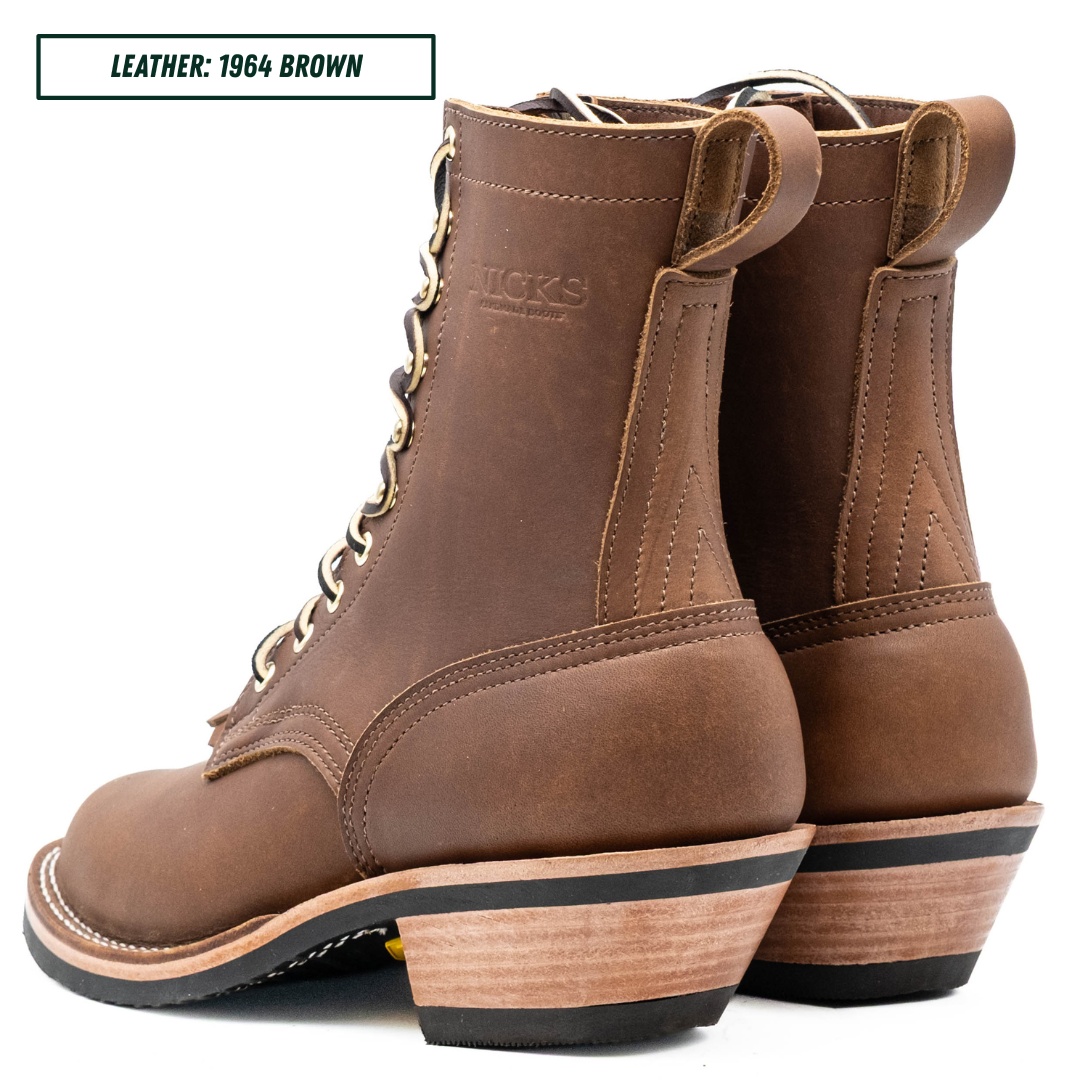 A pair of brown leather lace-up boots shown from the side and back on a white background, with a text label in the top-left corner reading 'LEATHER: 1964 BROWN'. The boots feature a stacked wood-look heel with a black rubber outsole.