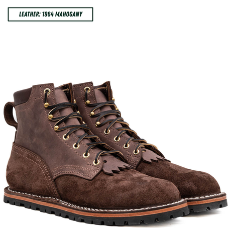 A pair of dark brown suede lace-up boots with gold-tone eyelets and black laces, shown on a white background with a text label reading 'LEATHER: 1964 MAHOGANY' in the top left corner.