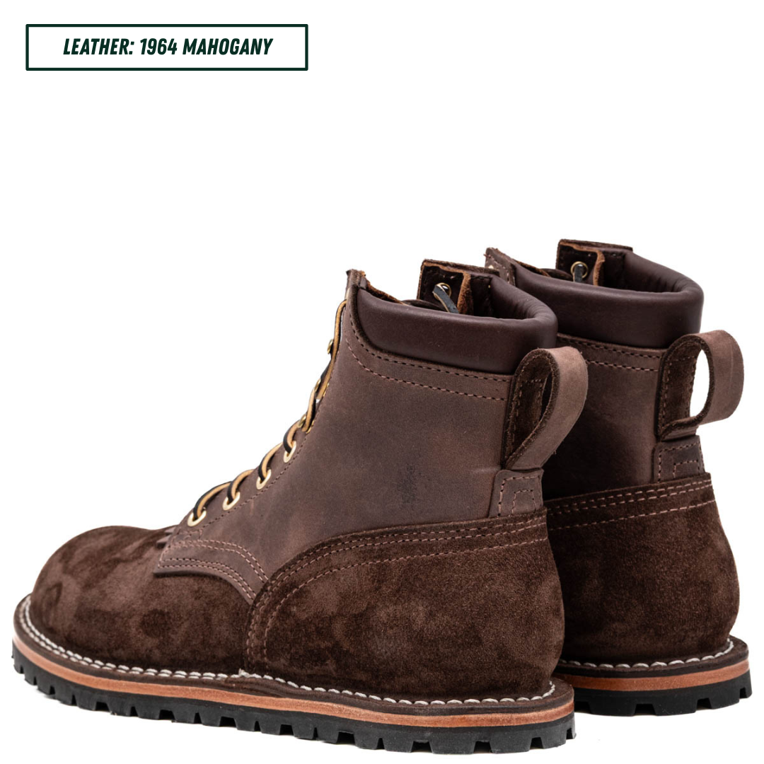A pair of dark brown leather lace-up boots with a suede-like finish, shown from the side and back on a white background. A text label in the top-left corner reads 'LEATHER: 1964 MAHOGANY'.