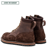 A pair of dark brown leather lace-up boots with a suede-like finish, shown from the side and back on a white background. A text label in the top-left corner reads 'LEATHER: 1964 MAHOGANY'.