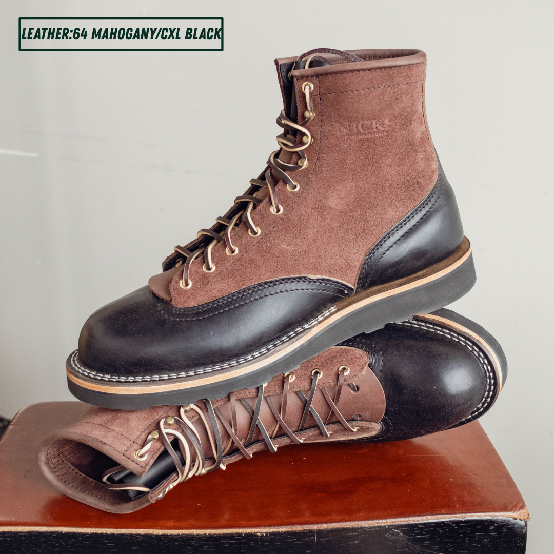 Two tone boots with dark brown roughout uppers and glossy black lowers on a wooden stool. One boot sitting upright on the other laying on its side. Top left reads 'LEATHER:64 MAHOGANY/CXL BLACK'