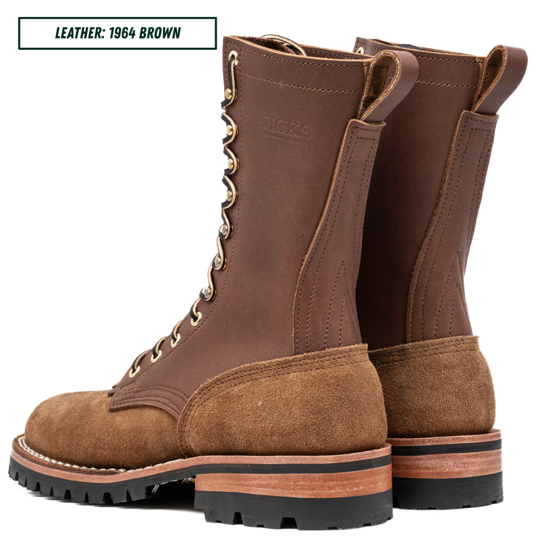 A pair of brown leather lace-up boots with a suede toe and heel, shown from the side on a white background. A text label in the top-left corner reads 'LEATHER: 1964 BROWN'.