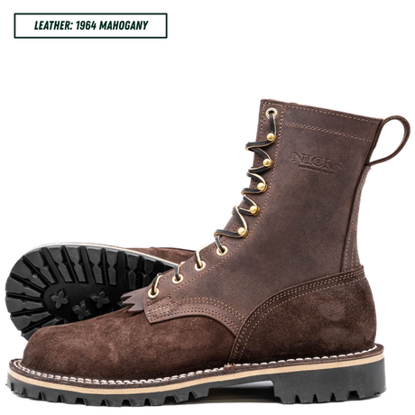 A pair of Nicks 1964 Mahogany leather lace-up work boots in dark brown, featuring gold-tone eyelets, white welt stitching, and a black lug sole. One boot is shown in profile with the treaded sole visible, and a text label in the top left reads 'LEATHER: 1964 MAHOGANY'.