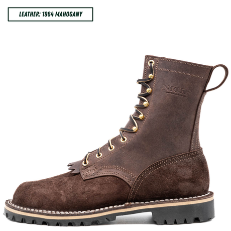 A single dark brown suede and leather work boot shown in profile on a white background, with a text label in the top-left corner reading 'LEATHER: 1964 MAHOGANY'. The boot has gold-tone eyelets and laces, a pull loop, and a thick black lug sole with a light tan midsole stripe.