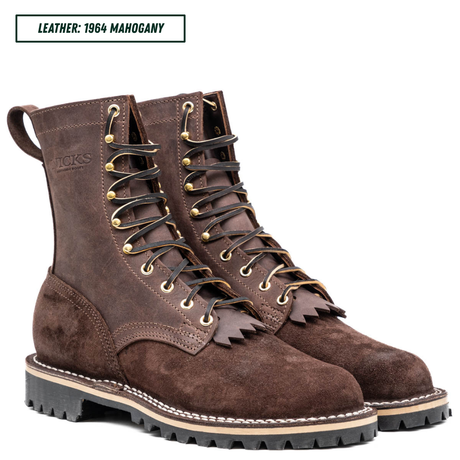 A pair of dark brown leather lace-up boots with gold-tone eyelets, shown on a white background with a text label in the top left corner reading 'LEATHER: 1964 MAGOHANY'.