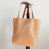 Veg Tan Suede Tote with no pocket, showing cattle brand hanging on boot jack.