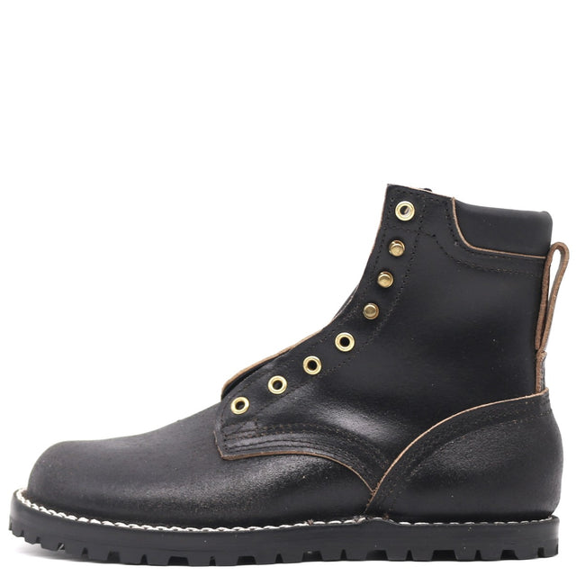 Black leather boot with gold buttons on a white background