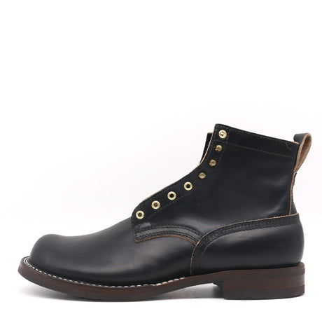 Black leather boot with gold buttons on a white background