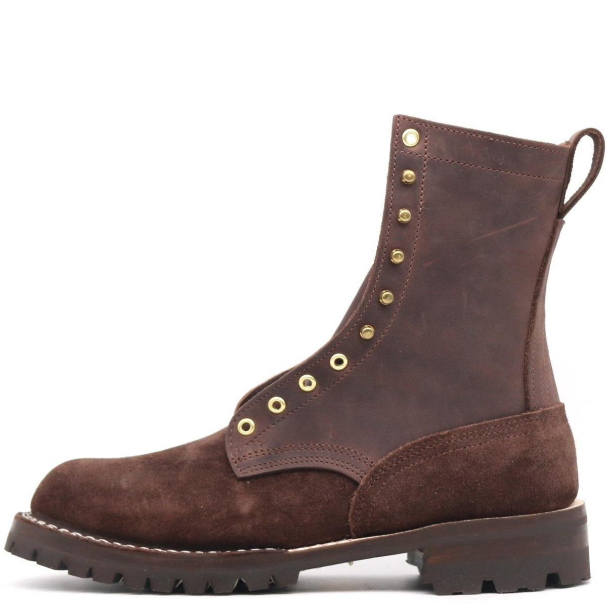A dark brown suede lace-up ankle boot with brass eyelets and studs, a pull tab, and a rugged lug sole, shown from a side profile on a white background.