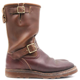 A mid-calf brown leather boot with decorative buckle straps, shown in a side profile view against a plain white background.