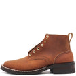 A brown suede lace-up ankle boot with brass eyelets, white contrast stitching, and a dark brown stacked sole, shown from a side profile on a white background.