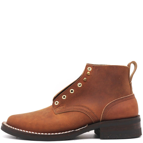 A brown suede lace-up ankle boot with brass eyelets, white contrast stitching, and a dark brown stacked sole, shown from a side profile on a white background.