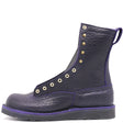 Dark purple boot with brass hardware on a black wedge sole, against a white background