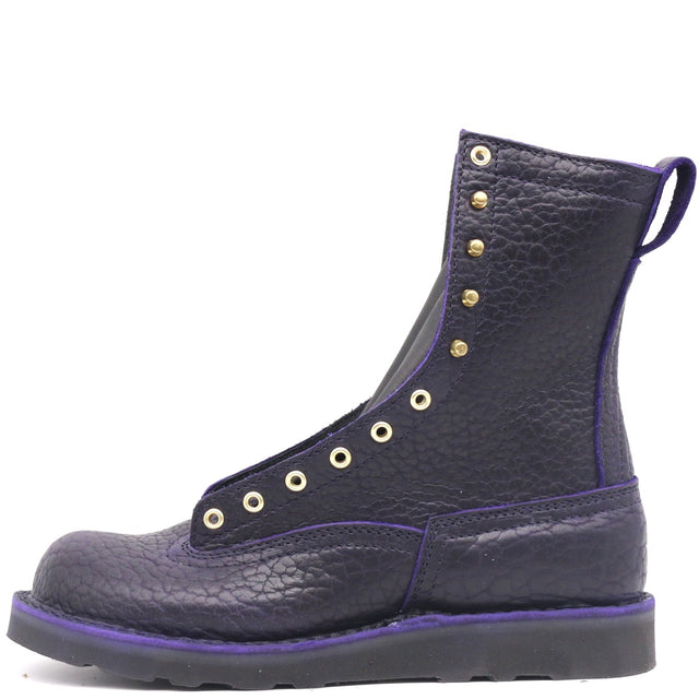 Dark purple boot with brass hardware on a black wedge sole, against a white background