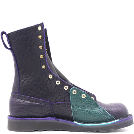 Dark purple boot with brass hardware on a black wedge sole and a bright turquoise lineman patch, against a white background