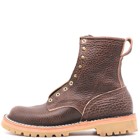 A dark brown textured leather lace-up boot with brass eyelets, contrast stitching, and a tan lug sole, shown from a side profile on a white background.